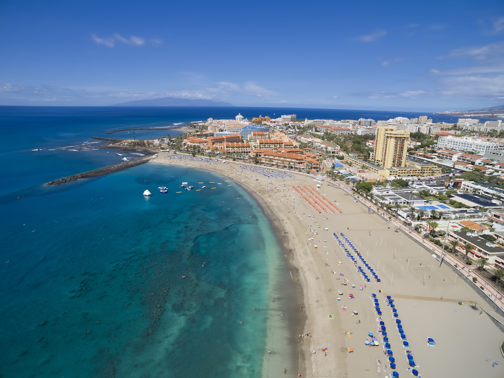 Aerial shot of beautiful beach and ocean in Adeje Playa de las Americas, Tenerife islands, Spain